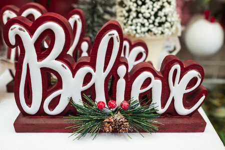 Believe word wooden Christmas decoration. Inspirational word BELIEVE with christmas decor. Nobody,...
