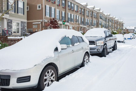 Car under snow in winter. Parked cars and the road are covered with a smooth layer of snow. Covering with snow line of vehicles snowfall at winter-Surrey BC Canada-December 1.2022のeditorial素材