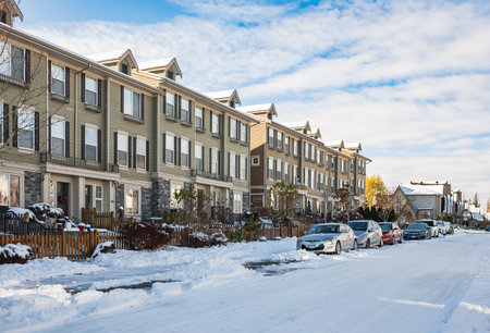 Snow covered residential street after heavy snow fall over night. Early sunny morning. A freshly plowed road in suburbia after a snow storm. Vancouver, British Columbia, Canada-December 2,2022のeditorial素材