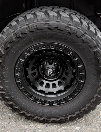 Big car wheel on a road. Closeup of big 4x4 car wheel mountain track. Offroad 4x4 concept. Nobody,...