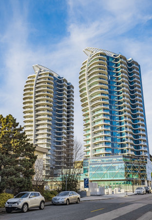 A high rise building against the blue sky. Condominium or apartment building. Looking Up Blue Modern Building. Architecture details Modern Building Glass facade-Surrey Canada-January 10,2023のeditorial素材