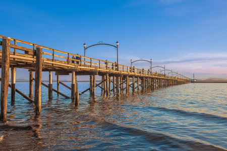 Pier on the sea at sunset. View of a wooden bridge Twilight. Colorful sunset over the White Rock...