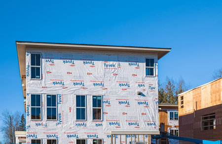 New low-rise apartments building construction. Housing construction in Surrey Canada. Residential building under construction. Street photo, nobody, selective focus-January 30,2023のeditorial素材