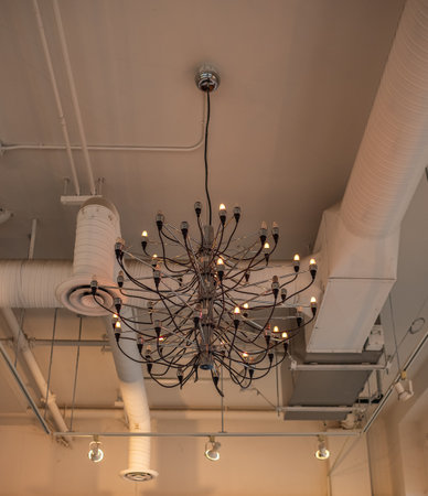 Lighting balls on the chandelier in the lamplight, light bulbs hanging from the ceiling, lamps on the dark background. Nobody, selective focusの写真素材