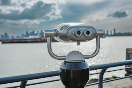 Tourist binocular by the beach on a sunny day. Street photo, nobody,copy space, travel photo.の写真素材