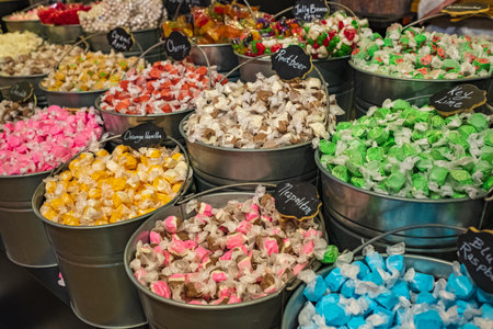 Buckets filled with taffy candy at a candy shop. A variety of candy in a store. Nobody, selective...
