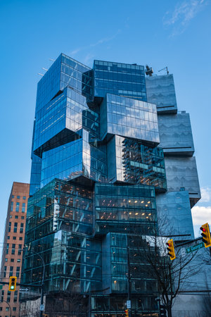 Modern apartment buildings in downtown Vancouver BC Canada. Angular Glass Tower Buildings Against Blue Sky. Abstract architecture of a modern city. Vancouver city financial district-March 22,2023のeditorial素材