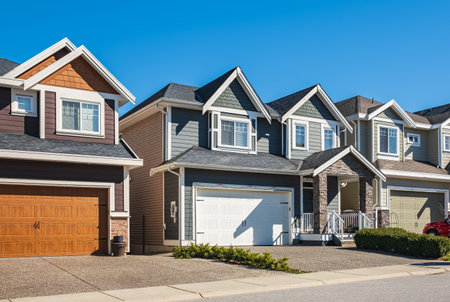 A perfect neighborhood. Houses in suburbs at Spring in the north America. Real Estate Exterior Front Houses on a sunny day. Big custom made luxury houses with nicely landscaped front yardの写真素材