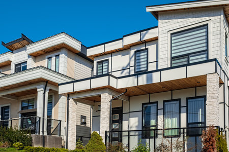 Real Estate Exterior Front House on a sunny day. Big custom made luxury house with nicely landscaped front yard in the suburbs of Vancouver Canada. Street photo, nobodyの写真素材