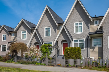 A perfect neighborhood. Houses in suburbs at Spring in the north America. Real Estate Exterior Front Houses. Big custom houses with nicely landscaped front yard. Roof shingles on top of the houseの写真素材