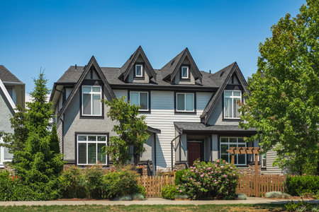A perfect neighborhood. Houses in suburbs at Spring in the north America. Real Estate Exterior Front Houses. Big custom houses with nicely landscaped front yard. Roof shingles on top of the house