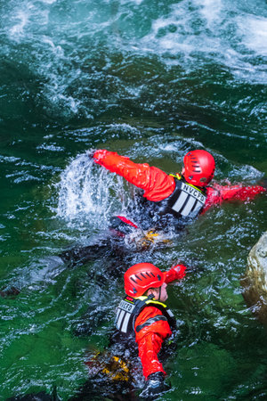 Fireman are training for rescue mission. Rescue team in action. A Fire and Rescue team working together to hone their life saving skills on a flooded river. Vancouver-Canada-June 1, 2023のeditorial素材