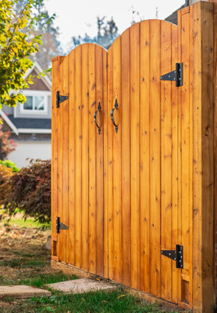 Entrance of house with beautiful new wooden gates. Gateway background. Traditional wooden closed...
