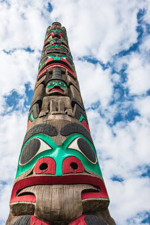 Totem pole by North American Native Indians. Totem poles are monumental sculptures carved by...