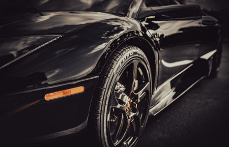 Close up black sport car Lamborghini on the street. View of Lamborghini supercar. Black Lamborghini parked on a street in Vancouver Canada-September 7, 2023-street photo, nobodyのeditorial素材