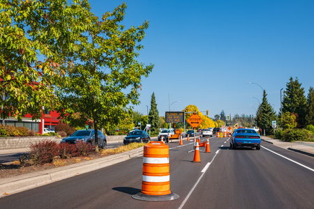 Orange cones set up to direct traffic. Construction site is repairing asphalt road pavement,road...