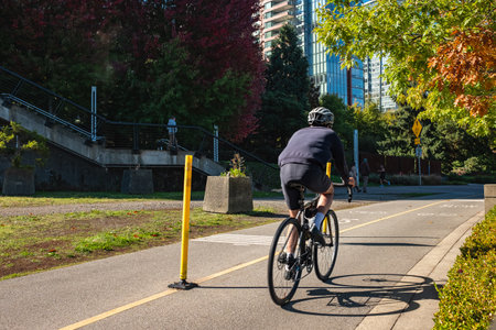 Back view of a man athlete wearing helmet on bike ride. Bikes on Bicycle Path. Ride a bicycle....