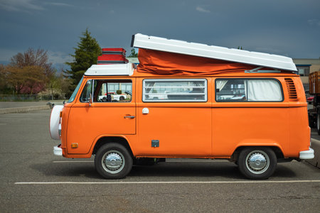 Volkswagen vintage bus. Retro van hippie camper car on a street of the city. Orange Volkswagen Van. German VW Camper van on parking place. Vintage hippie van vehicle-May 1,2023-Vancouver Canadaのeditorial素材
