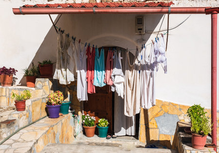 Rope with clean clothes outdoors on laundry day in rural Europe. Clothes-line laundry. Different clothes drying on laundry line at the backyard of a house. Travel photo, nobodyの写真素材