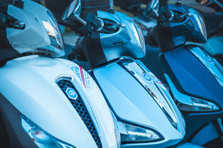 Close up of an brand new scooters parked up in a row. Electric scooters for rent. Row of electric scooters parked in the cityのeditorial素材