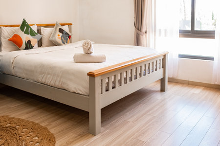 Nice bed in bedroom. Stylish room interior with big comfortable bed. Modern bedroom interior in...