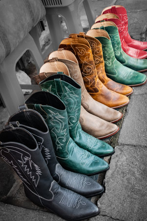 Cowboy boots for sale in shop. Leather colorful cowboy boots with embroidery. Travel photo, nobodyの写真素材