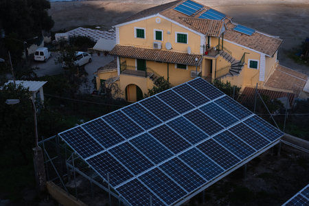 Rural scene of a house with photovoltaic panels. Solar panel, renewable energy source. Dark solar...