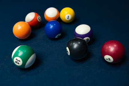 Pool balls in random order. Close-up of a billiard balls in different colors. Sports game of billiards on a blue cloth. Snooker balls are ready for play. Nobodyの写真素材