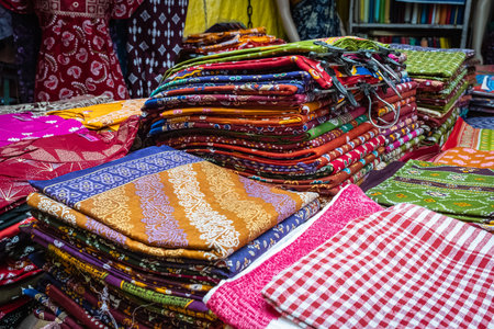 Colorful fabrics for sale in the market. Cotton textiles with colorful patterns in the shop. Colored...
