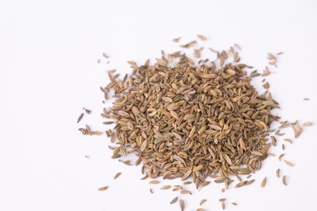 Dried raw organic fennel seeds. Closeup fennel seeds on bowl isolated on white by top view. Heap...