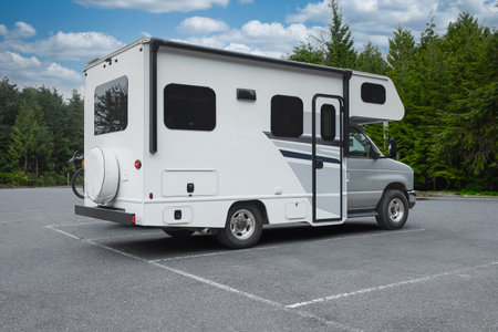 A motor home camper ready to holidays near lake or river in road trip vacation. Mini RV Camper...