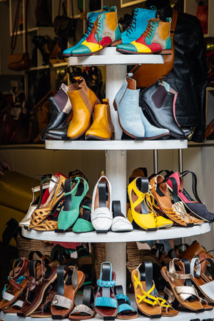 Street market selling quality leather handmade shoes, boots and sandals. Summer shoes, variety of...