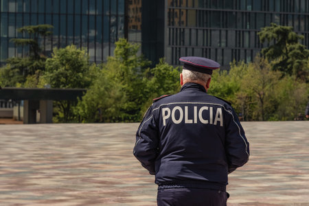 An old man wearing police uniform walking on the street of Europe. Back view of policemen patrolling in the street. Copy space for textの写真素材