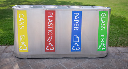 Garbage assorting trashcans on the street. Recycling bins for paper, bottles, cans, plastic in the public park. Trash bins and assorted garbage. Variety of Recycling Bins Collection. Nobodyの写真素材