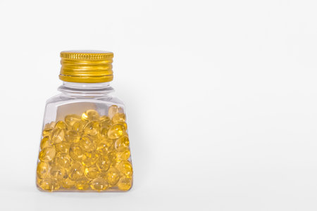 Oil filled capsule, soft gel, Fish oil supplement capsule in clear plastic bottle, omega 3, vitamin A, D. Fish oil supplement capsules in transparent bottle isolated on white background.の写真素材
