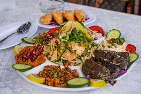 Middle Eastern traditional dinner. Authentic Arabian cuisine food. Assorted of middle eastern traditional dishes, fattoush salad, Halal food, stuffed vine leaves. Top view,selective focusの写真素材