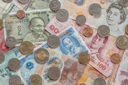 Cash money World Currencies Banknotes, coins from different countries top view, financial Concept Background. Turkish lira, Vietnamese dong, Egyptian pound, UAE dirham, Indian rupee, British poundの写真素材