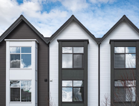 New upscale townhomes in a Canadian neighborhood. Development of new townhouses. Facade of a row of modern urban residential architecture. Real Estate Exterior Front townhomes. Nobody, street photoの写真素材