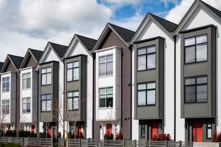 New upscale townhomes in a Canadian neighborhood. Development of new townhouses. Facade of a row of modern urban residential architecture. Real Estate Exterior Front townhomes. Nobody, street photoの写真素材