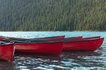 Red canoes floating on turquoise glacial lake. Beautiful red canoes docked at Lake Louise, Alberta, Banff National Park Of Canada. Travel photo, nobodyの写真素材