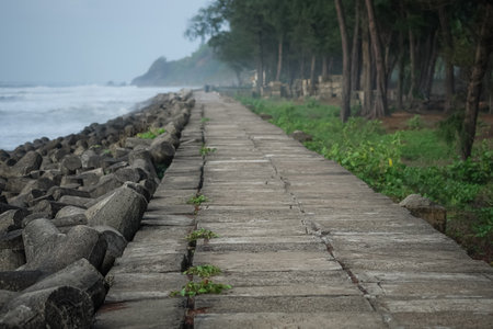 Walkway and massive concrete tetrapods along the seashore walkway to prevent waves coming to shore....