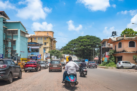 Cars on urban street in India. Typical busy Indian street with traffic. Cars and motorbikes on a road in Goa, India. Local commuters on motorcycles navigate busy traffic. travel photo-Sept 9,2025のeditorial素材