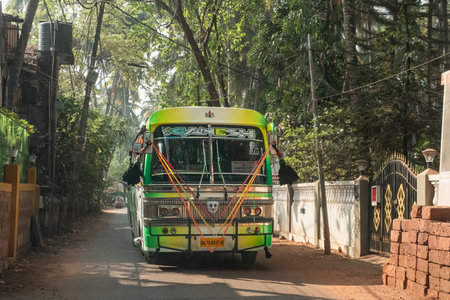 Passenger bus on its way in a village. Local public bus running on the rural road in countryside of...