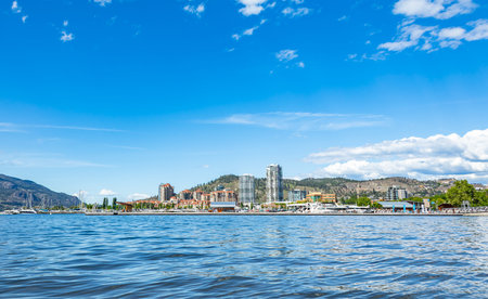 A view of the Kelowna Skyline and Okanagan Lake British Columbia Canada in the summer. Cityscape on sunny summer day. Travel photo, nobody, copy space for textの写真素材