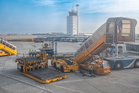 Cargo equipment car loader for luggage. Yellow car with luggage trailer at the Tan Son Nhat Saigon Ho Chi Minh International Airport Vietnam. Pre-flight service airport-Mar 26,2024