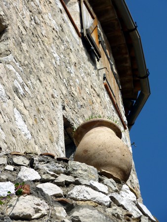Brown pottery standing on the wall of a house in Eze historical village, south of Franceの写真素材