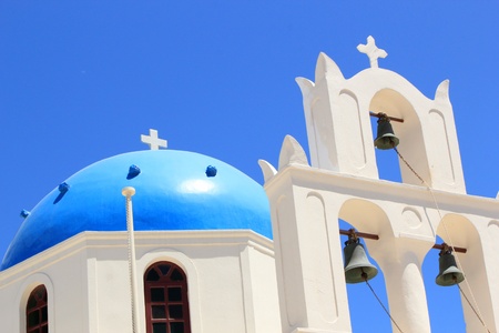 Close up of the blue dome and belfry of a church at Oia, Santorini, Greece, by beautiful weatherの写真素材
