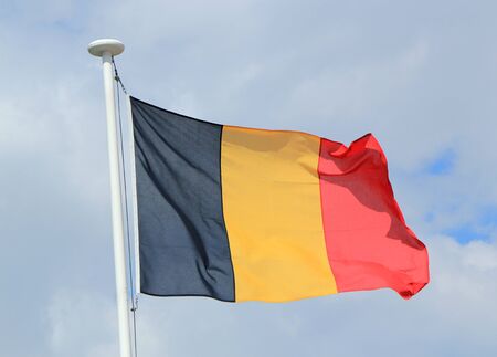 Flag of Belgium against cloudy skyの写真素材