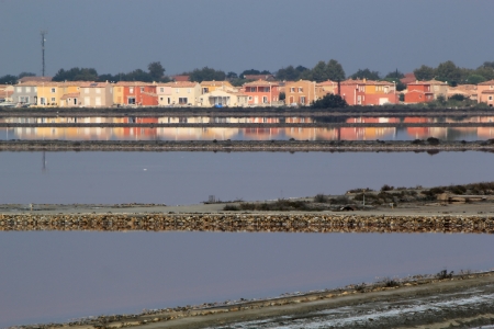 Colorful houses reflecting in water at Salin de Giraud, Camargue, Franceの写真素材