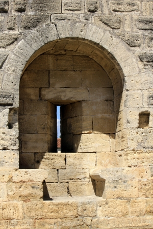 Close up on one loop hole in famous fortification wall surrounding Aigues-Mortes city, Camargue, Franceの写真素材